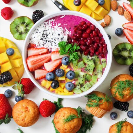 Assorted sliced fruits in white ceramic bowl